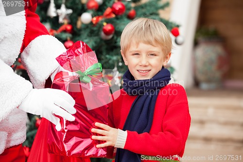 Image of Boy Taking Gift From Santa Claus