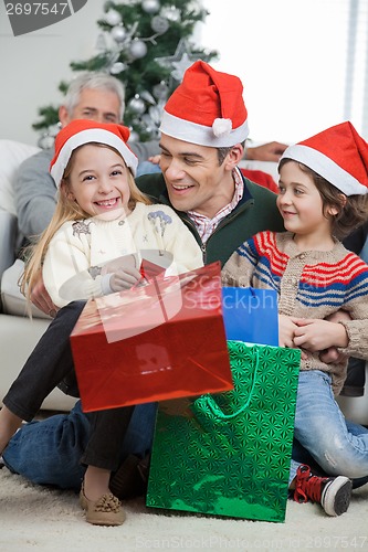 Image of Siblings And Father With Christmas Presents