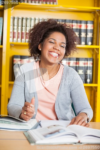 Image of Student With Eyes Closed Sitting At Table In Library