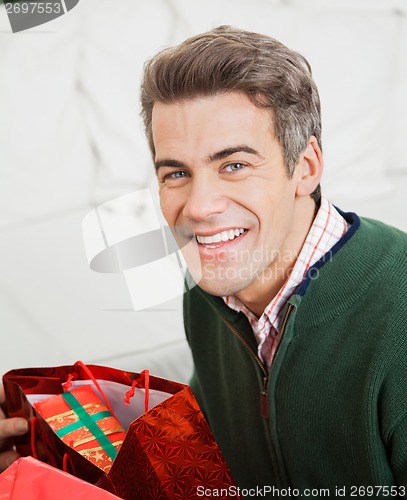 Image of Happy Man With Bag Of Christmas Presents