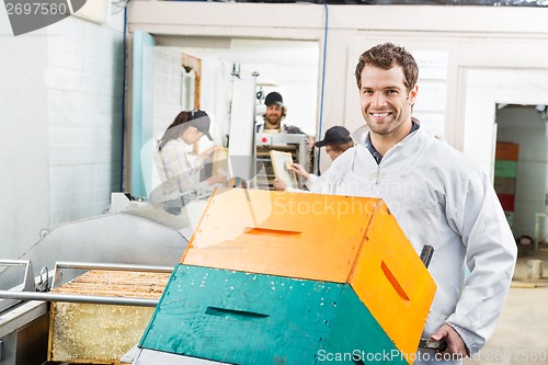 Image of Beekeeper Holding Trolley Of Stacked Honeycomb Crates