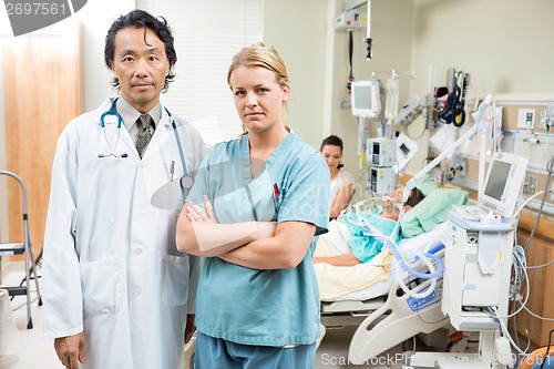 Image of Confident Doctor And Nurse With Patient Resting In Hospital