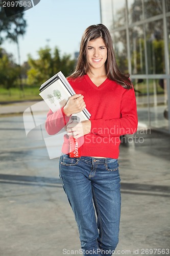 Image of Woman Holding Juice Bottle And Books At University Campus