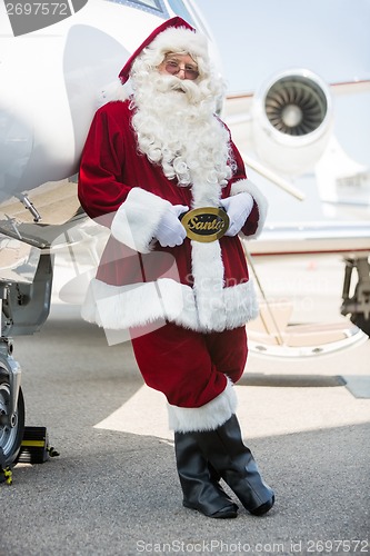 Image of Santa Leaning On Private Jet At Airport Terminal