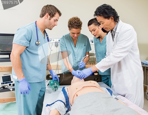 Image of Doctor Instructing Nurses In Hospital Room