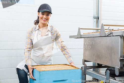 Image of Female Beekeeper With Honeycomb Box At Factory