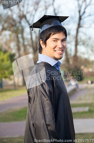 Image of Happy Man In Graduation Gown On University Campus