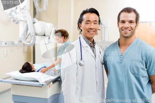 Image of Happy Medical Team With Patient In Hospital Room