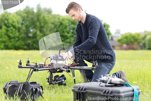 Image of Engineer Preparing Surveillance Drone in Park