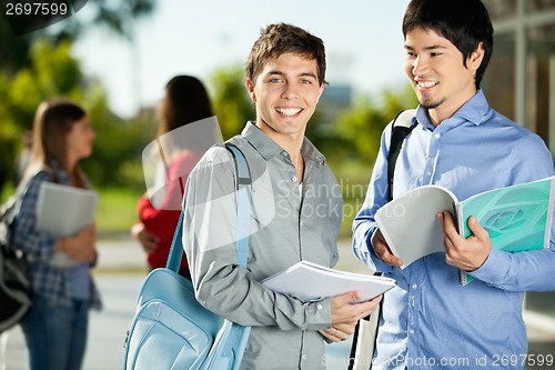Image of Man With Friend Standing On College Campus