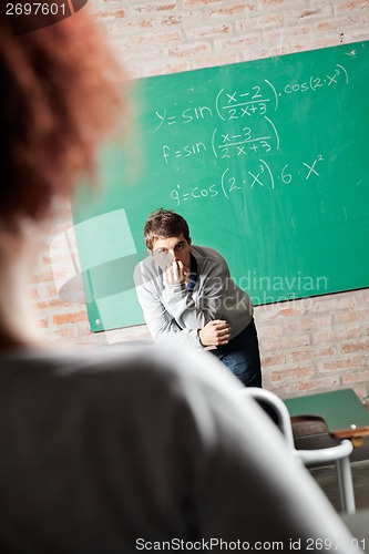 Image of Student With Hand On Chin Looking At Friend In Classmate