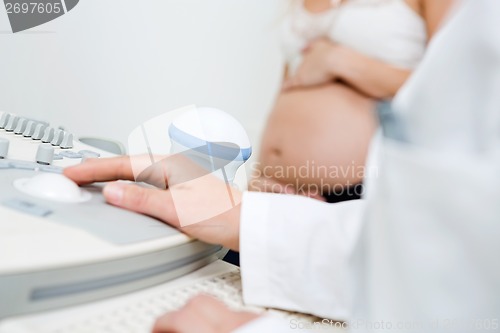 Image of Gynecologist Using Ultrasound Machine
