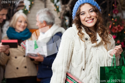 Image of Happy Woman With Family In Christmas Store