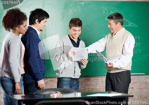 Image of Professor Giving Exam Result To Student At Classroom