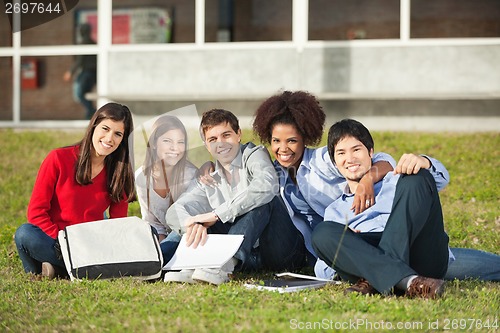 Image of Students Sitting On Grass At College Campus