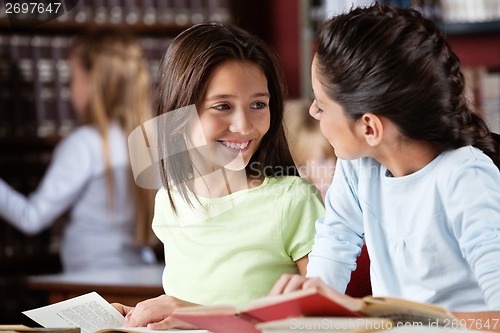 Image of Schoolgirl Looking At Female Friend In Library