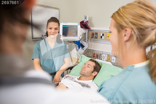 Image of Nurse Examining Patient In Hospital