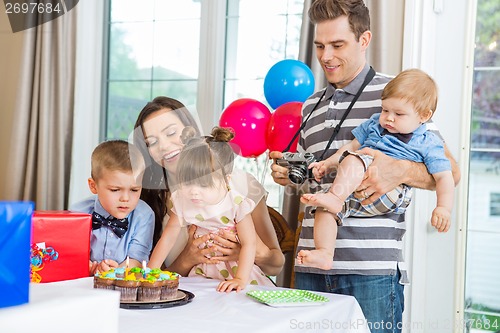 Image of Family Celebrating Birthday Party At Home