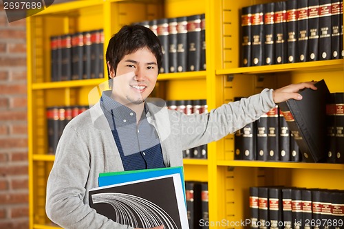 Image of Student Choosing Book From Shelf In Library