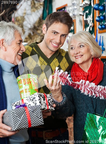 Image of Man With Parents Shopping In Christmas Store