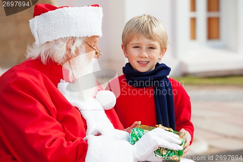 Image of Boy Taking Present From Santa Claus