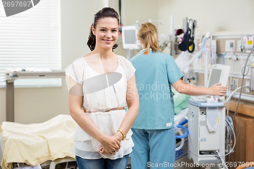 Image of Woman With Nurse Examining Patient In Hospital