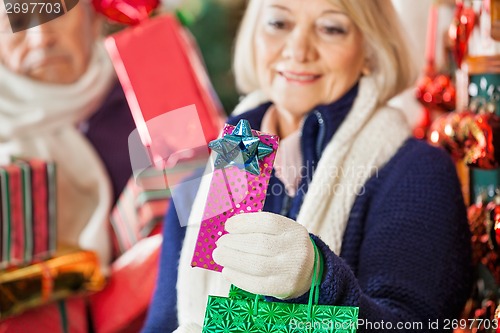 Image of Woman Holding Present In Christmas Store