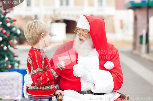 Image of Boy Giving Wish List To Santa Claus