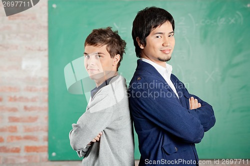 Image of Students Standing Arms Crossed Against Greenboard In Classroom