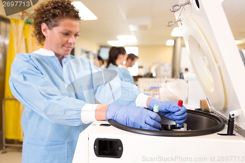 Image of Researcher Loading Samples in Centrifuge