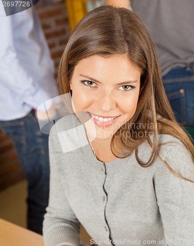 Image of Woman Smiling With Students Standing In Background At Library