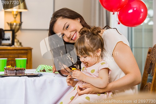 Image of Woman With Daughter Eating Birthday Cake