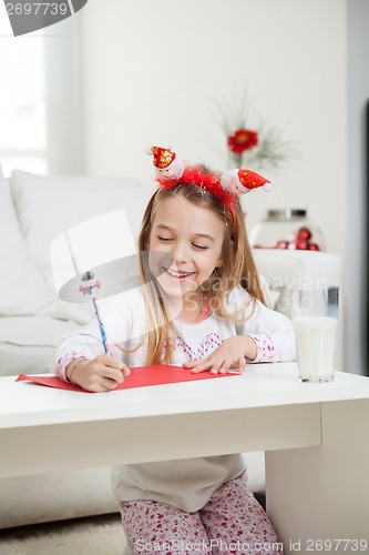 Image of Happy Girl Writing Letter To Santa Claus