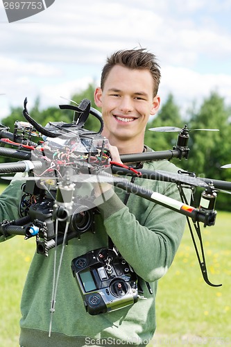 Image of Young Engineer Holding UAV Helicopter