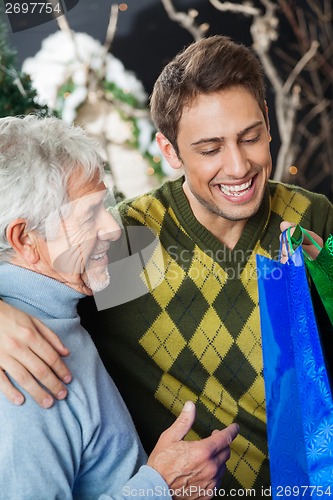 Image of Happy Father And Son In Christmas Store