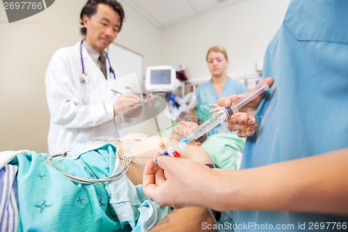 Image of Nurse Injecting Dosage In IV Tube