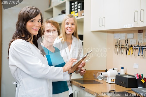 Image of Opticians Using Digital Tablet In Workshop