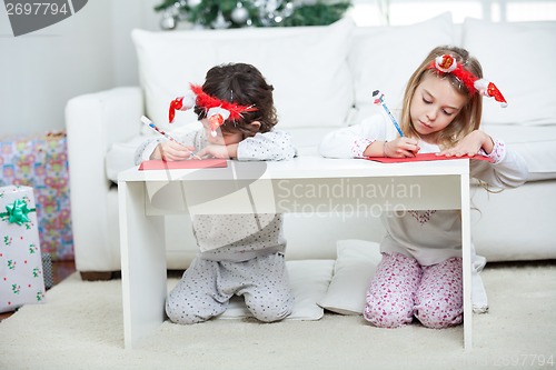 Image of Children Writing Letter To Santa Claus During Christmas