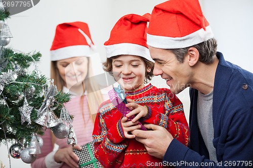 Image of Father And Son Opening Christmas Gift