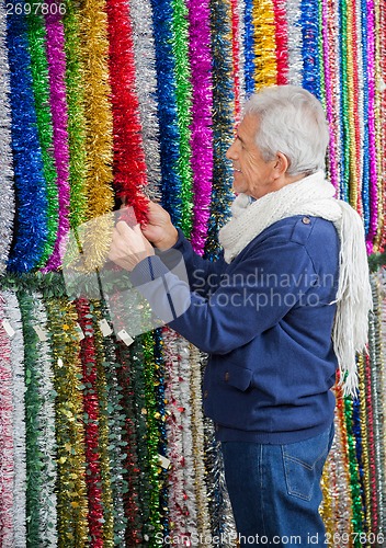 Image of Senior Man Shopping For Tinsels