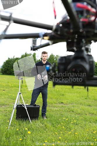 Image of Engineer Operating  UAV Octocopter in Park
