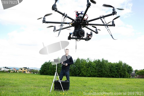 Image of Male Technician Flying UAV Octocopter