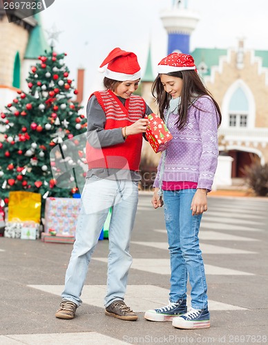 Image of Friends Opening Christmas Present