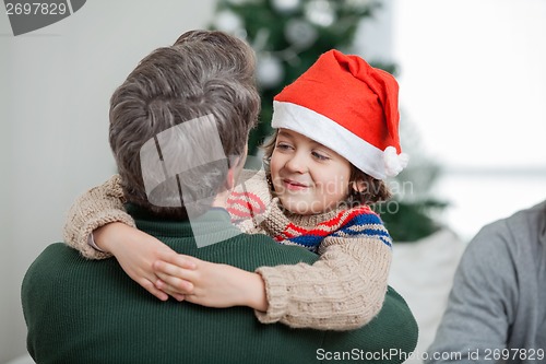 Image of Son Embracing Father During Christmas