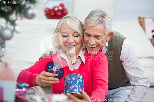 Image of Happy Senior Couple Looking At Christmas Gift