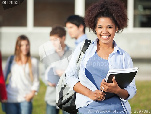Image of Woman Holding Books On University Campus
