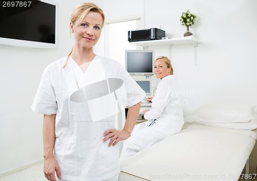 Image of Confident Gynecologist With Colleague In Background