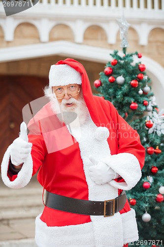 Image of Confident Santa Claus Gesturing Thumbsup