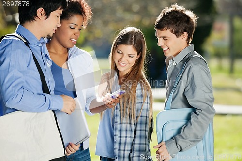 Image of Student Showing Mobilephone To Classmates In College Campus