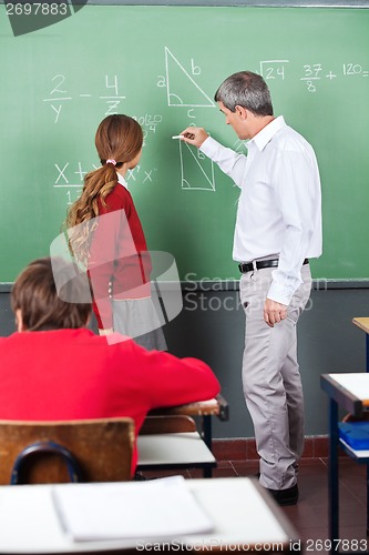 Image of Professor Teaching Mathematics To Teenage Schoolgirl